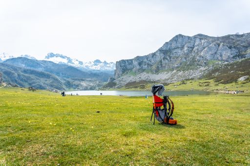 A backpack to transport babies in Lake Ercina in the Lakes of Covadonga on a sunny day, Asturias, Spain