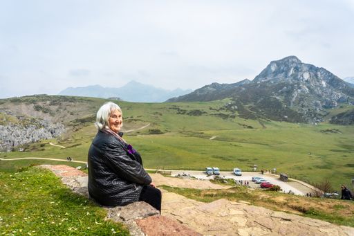 A beautiful shot of a Caucasian elderly woman at the entrelagos viewpoint of Lake Ercina in the Lakes of Covadonga, Asturias, Spain