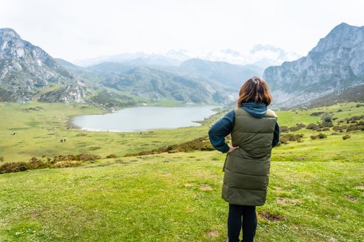 A back shot of a tourist at the Entrelagos viewpoint of Lake Ercina in the Lakes of Covadonga, Asturias, Spain