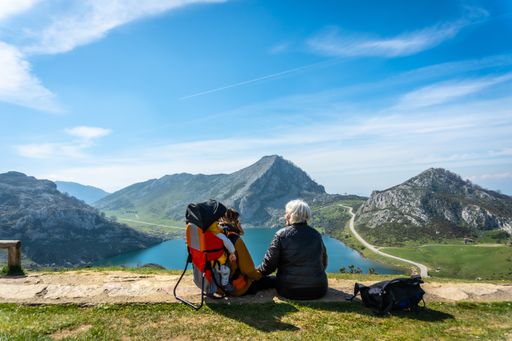A Grandmother, mother and son looking at Lake Enol in the Lakes of Covadonga. Asturias. Spain