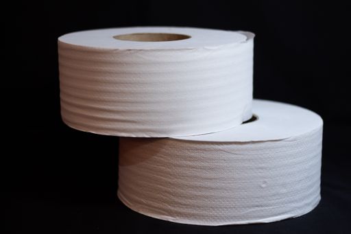 A closeup shot of toilet paper rolls on black background