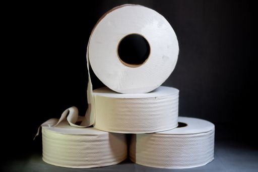 A closeup shot of toilet paper rolls on black background