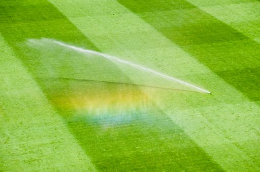 An irrigation turf working on the fresh green grass on the football field
