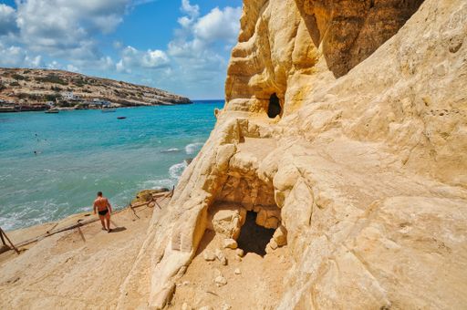 Matala beach through caves on the rocks that were used as a roman cemetery, Crete island Greece