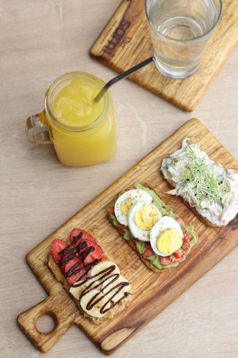 A serving of toasts with orange juice and water on the table