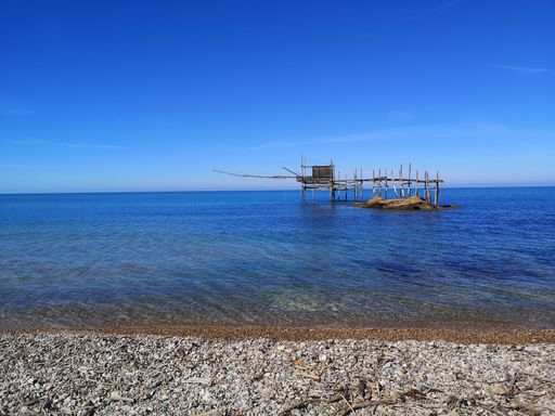 An offshore wooden platform with a blue sky in the background
