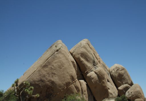 A view of big rock formations under blue bright sky