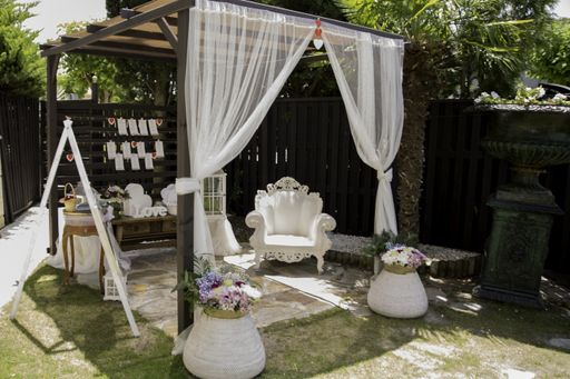 A gazebo with wedding decorations in the yard