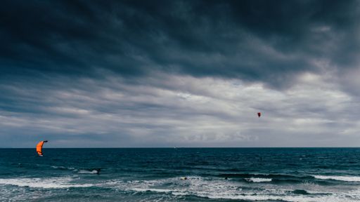 A breathtaking view of the white waves under the cloudy sky in stormy weather in Portugal
