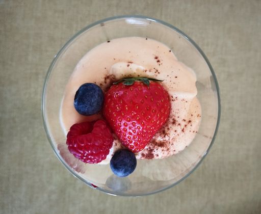A top view of yogurt with berries in the glass