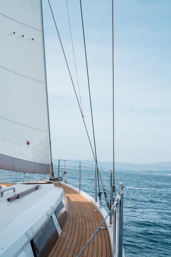 A vertical shot of a sailing ship on the sea under a cloudy sky in Croatia