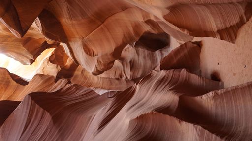 A vertical shot of the inside of mesmerizing Antelope Canyon with its reddish rocks in Arizona