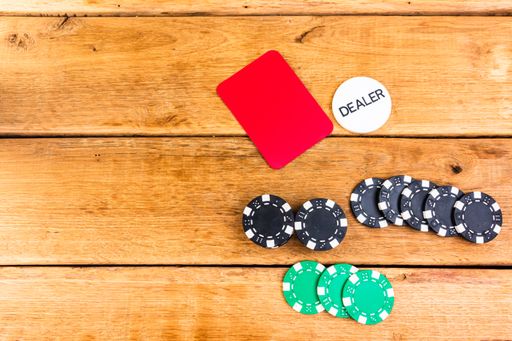 A top view of stacks of poker chips on a wooden background