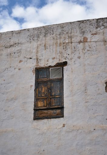 An old wooden window of an aged building