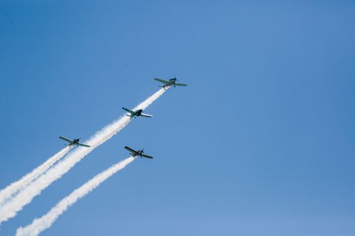 A low angle shot of an aircraft display flying in a blue sky over Malaga, Spain