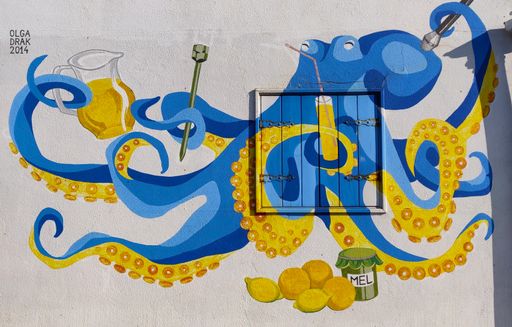 Colorful graffiti of an octopus drinking poncha in Madeira, Portugal