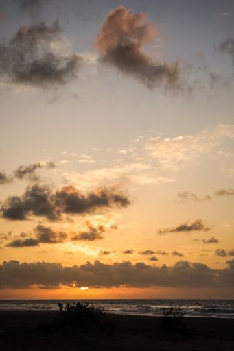 A beautiful view of an orange sunset over the sea