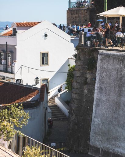 A vertical shot of the Portas do Sol viewpoint full of tourists, Lisbon, Portugal