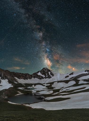 A beautiful night landscape with the Milky Way and small alpine lake