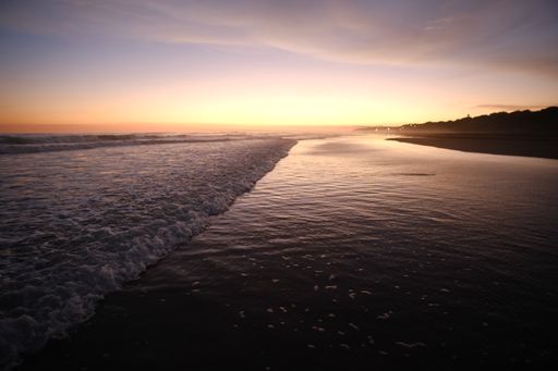 A beautiful beach colored by the sunset