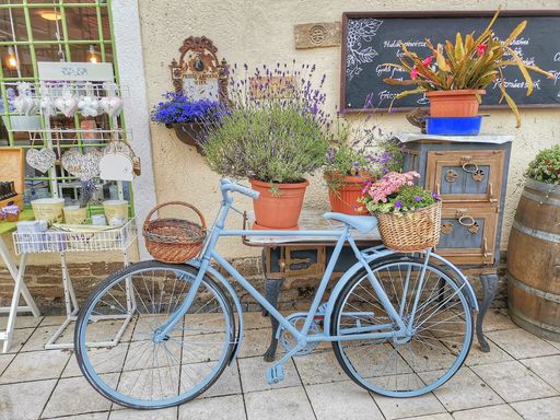 A blue bicycle with a beautiful flower basket