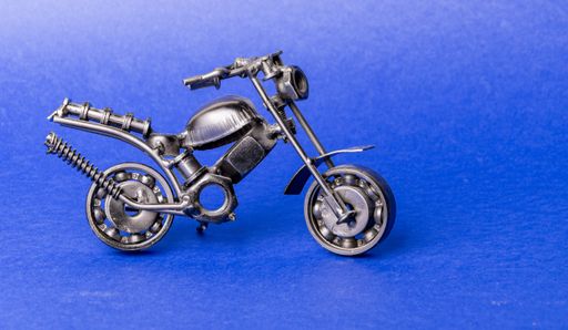 Homemade metal model toy sports motorcycle  on a blue background