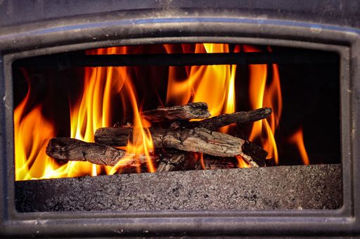 A woodpile burning in a fireplace