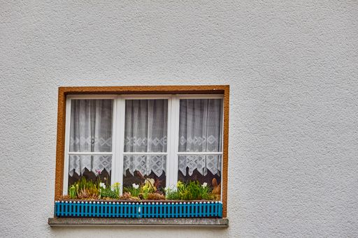 A beautiful exterior window with pot plants in the old village Monreal buildings, Germany