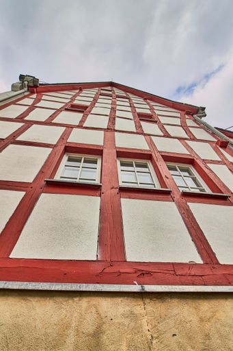 A low angle shot of a traditional building in the old village Monreal buildings, Germany with a blue cloudy sky