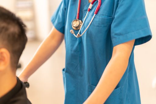 Closeup of a female doctor helping disable patient in wheelchair