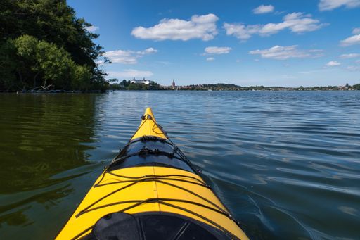 yellow Kayak on ploner ploener  lake in background plon castle, Ploen Germany