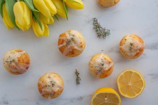 A closeup shot of vanilla muffins with lemons on the white background