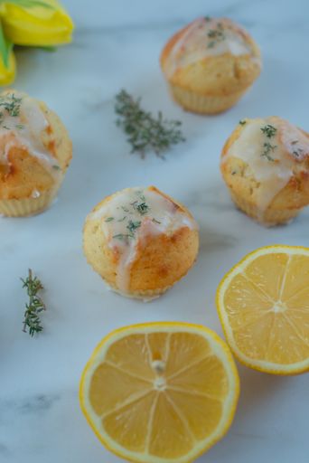 A vertical shot of vanilla muffins with lemons isolated on the white background