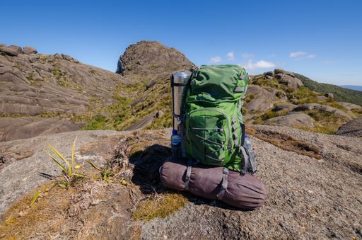 A closeup shot of a green hiking backpack on the mountain at daytime
