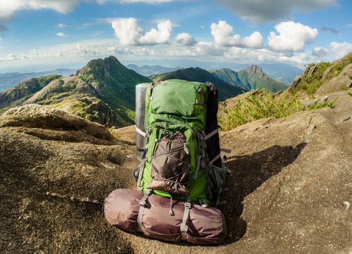 A closeup shot of a green backpack on the mountain at daytime