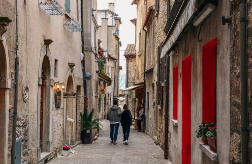 A couple walking through the historical street in San Marino