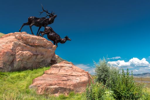 A low angle shot of metal deer sculptures on a rock in Jackson, Wyoming, USA