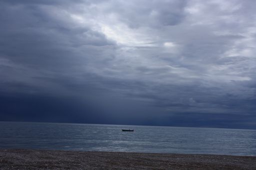 A beautiful shot of a dark seascape on a cloudy sky background