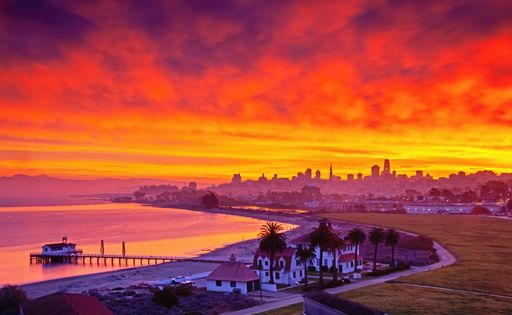 An aerial shot of a bright glowing sunset sky over San Francisco