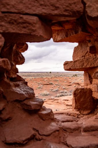 A view of the Wapatki National Monument near the Petrified Forest National Park through a cliff hole