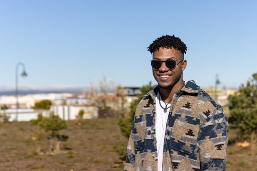 A portrait of smiling man wearing sunglasses outdoors on summer