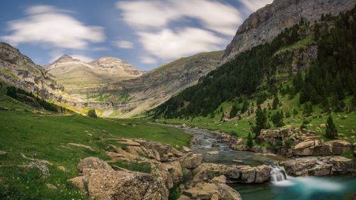 The Monte Perdido and Ordesa valley with a waterfall in Ordesa y Monte Perdido, Pyrenees, Spain