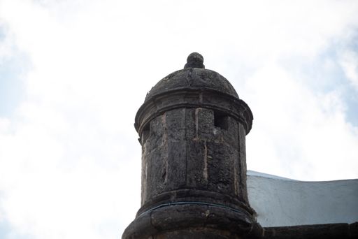A low-angle shot of a lighthouse fort against a blue cloudy sky on a sunny day in Salvador, Brazil