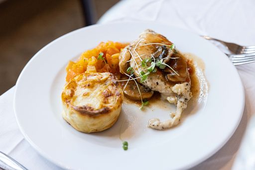 A tasty chicken and sweetcorn pie and Foie gras stake on white plate