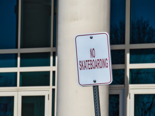 A view of the "no skateboarding" sign on the street