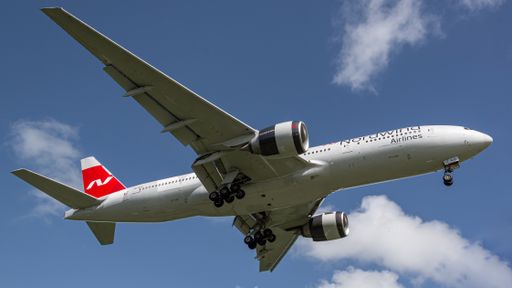 A low angle shot of a Nordwind Airlines Boeing 777 airplane flying from Varadero Airport international