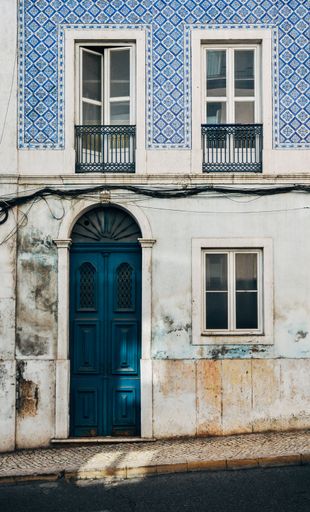 A vertical image of the facade of an old building in Lisbon, Portugal