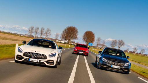 A beautiful 3 Mercedes AMG models driving on the road with autumn trees in the back in Netherlands