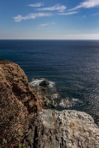 The cloudy blue sky over the sea captured from the coast in summer