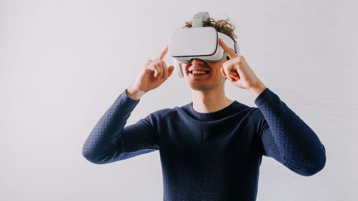 A young man exploring a new universe with VR glasses